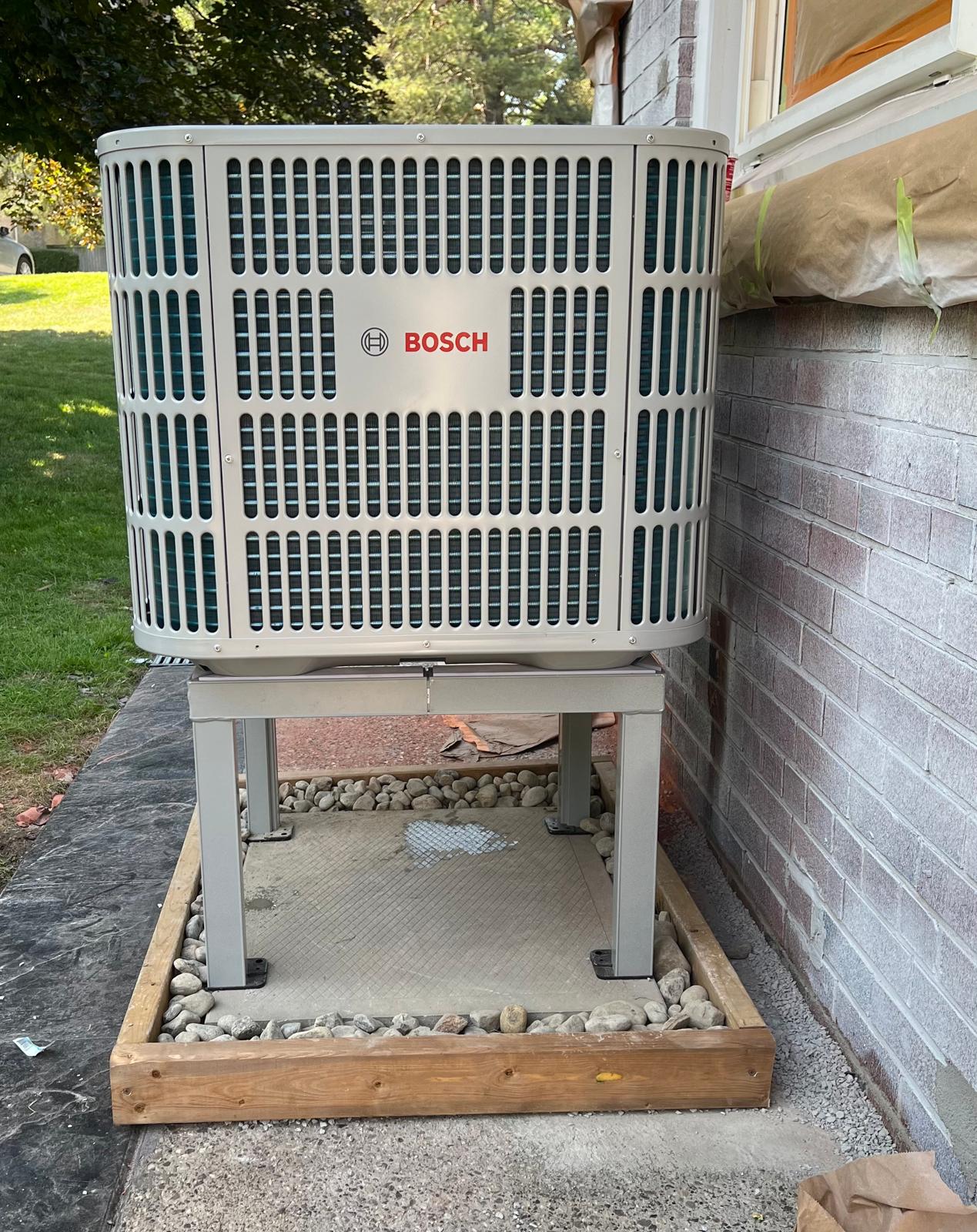 High-efficiency Bosch heat pump installed on a raised snow stand for optimal winter performance in Ontario.