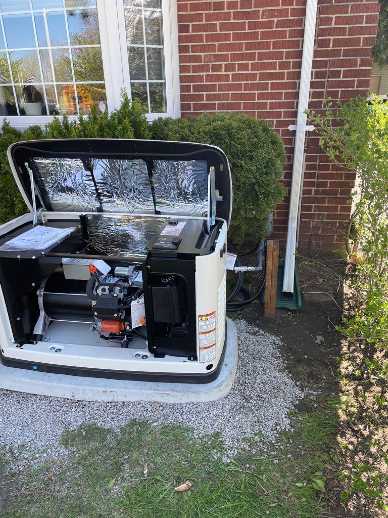 Generac whole-home backup generator with open lid during a professional maintenance and inspection service.