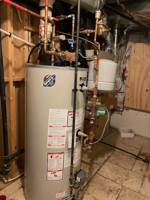 Water-heater connections and installation area being assessed