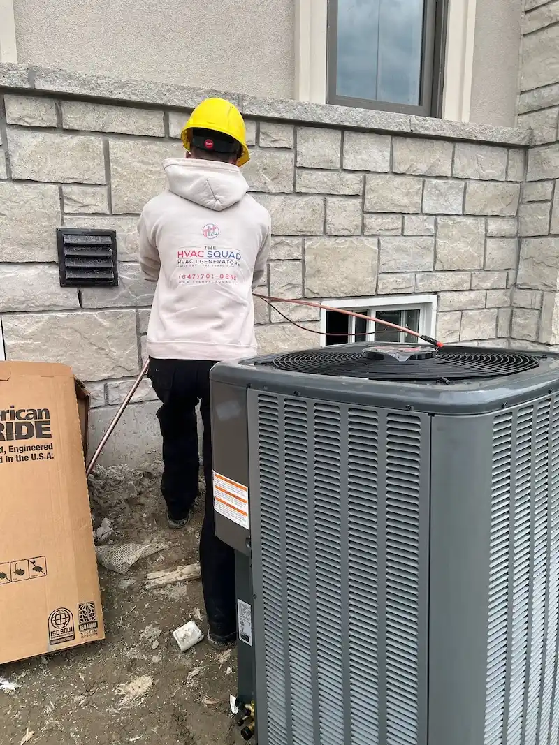 The HVAC Squad technician installing copper refrigerant lines for a new central air conditioning system in a Brampton home.